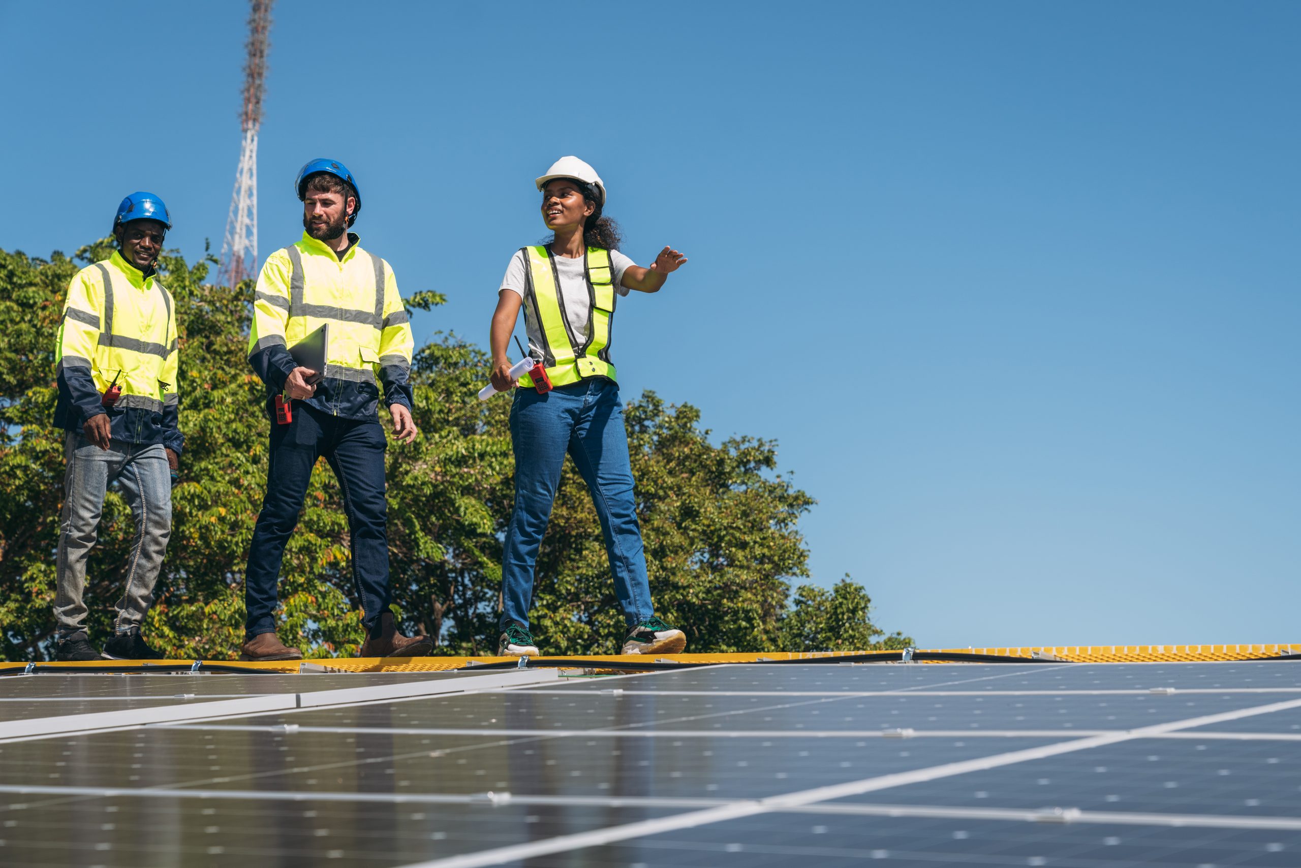 The engineer installs the solar panel, promoting the clean energy concept.